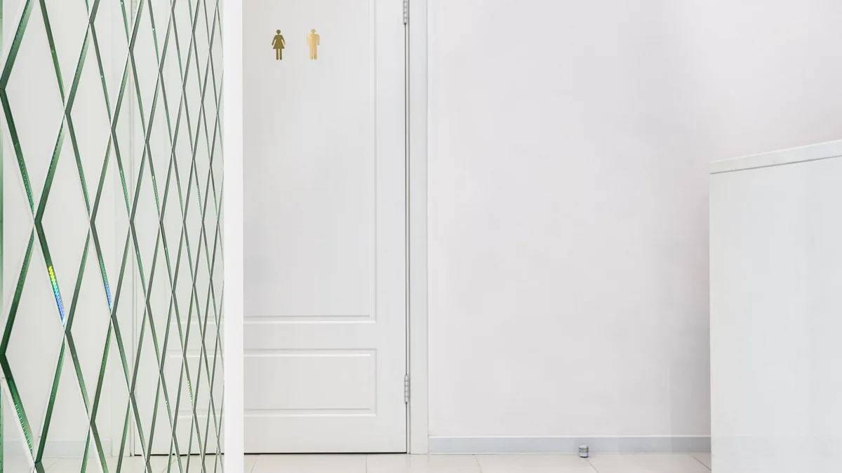 White hallway with a paneled door